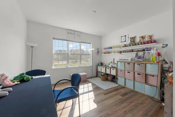 a bedroom with furniture and a window