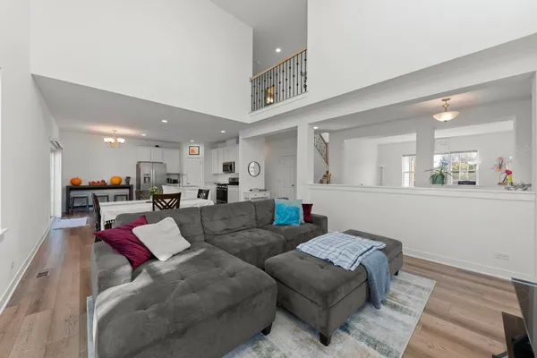 a living room with furniture and a view of kitchen