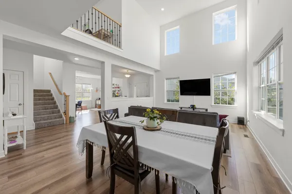 a view of a dining room with furniture and wooden floor