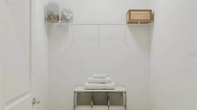 a bedroom with a bed and lamp