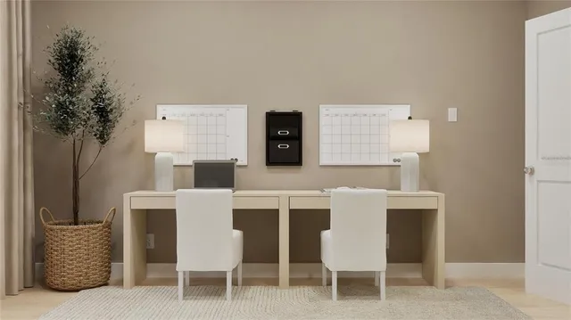 a kitchen with a table chairs and a potted plant
