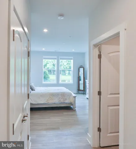 a bedroom with a bed and large windows