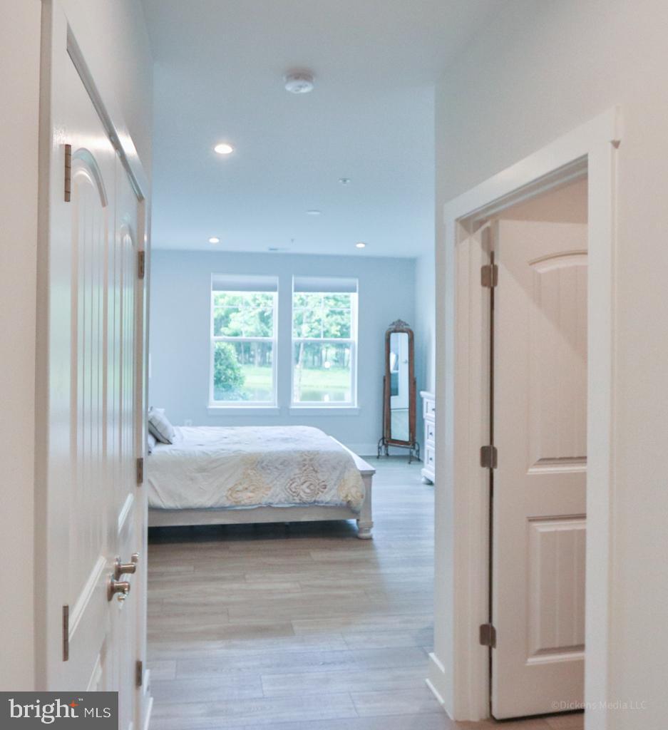 190 Harrier Way, Unit 11 Chester, MD 21619 - Photo 11 of 32 a bedroom with a bed and a window