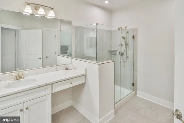 a bathroom with a double vanity sink mirror and shower