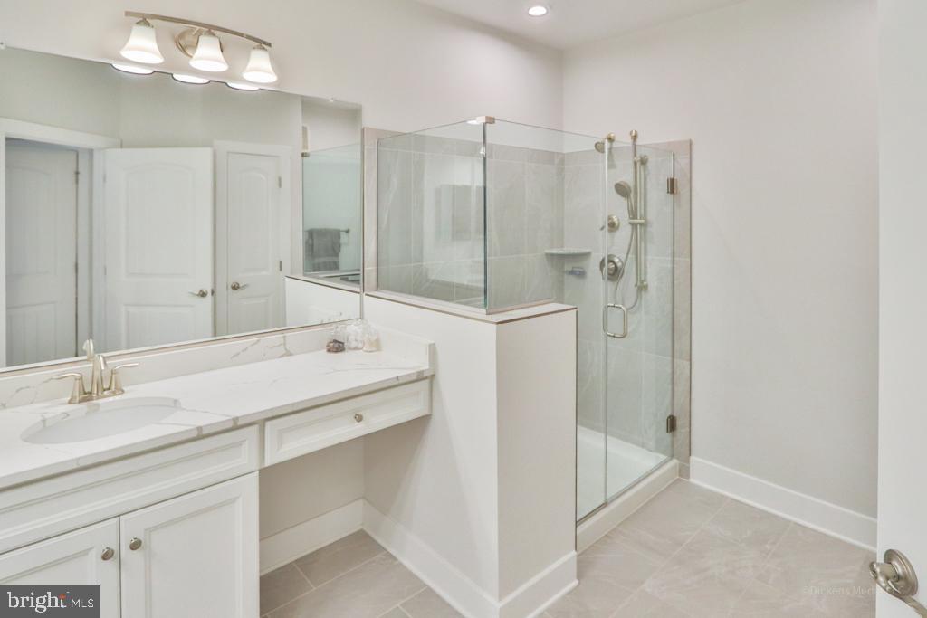 190 Harrier Way, Unit 11 Chester, MD 21619 - Photo 15 of 32 a bathroom with a shower sink and mirror