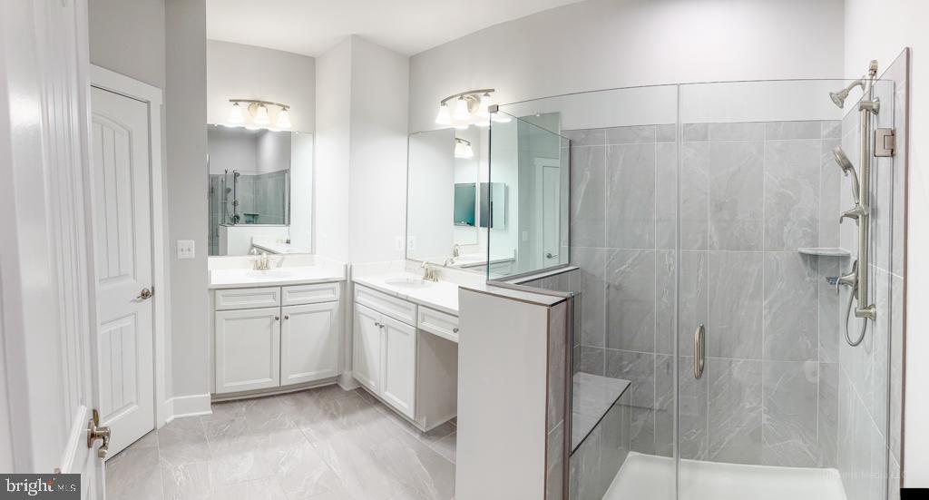 190 Harrier Way, Unit 11 Chester, MD 21619 - Photo 16 of 32 a bathroom with a double vanity sink mirror and shower