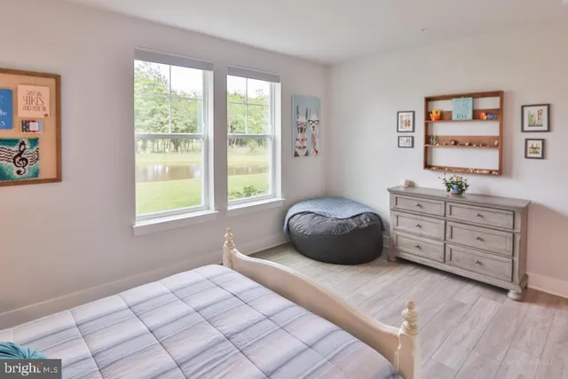 a living room with a bed furniture and a large window