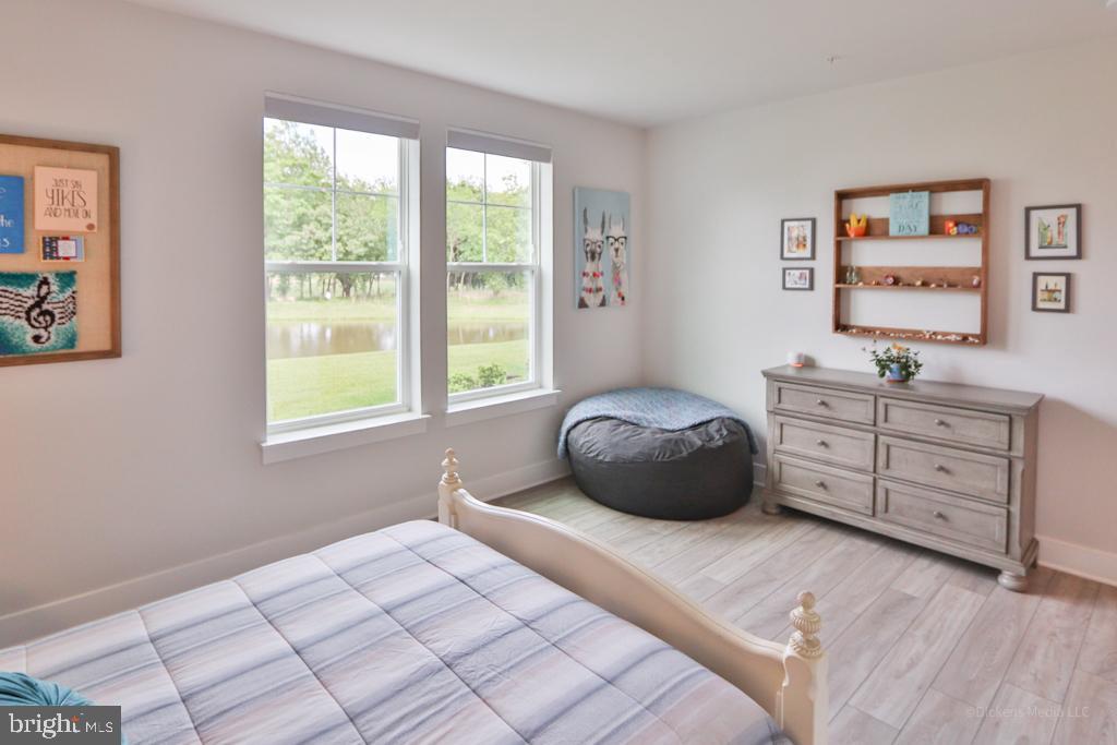 190 Harrier Way, Unit 11 Chester, MD 21619 - Photo 17 of 32 a bedroom with a bed and a window