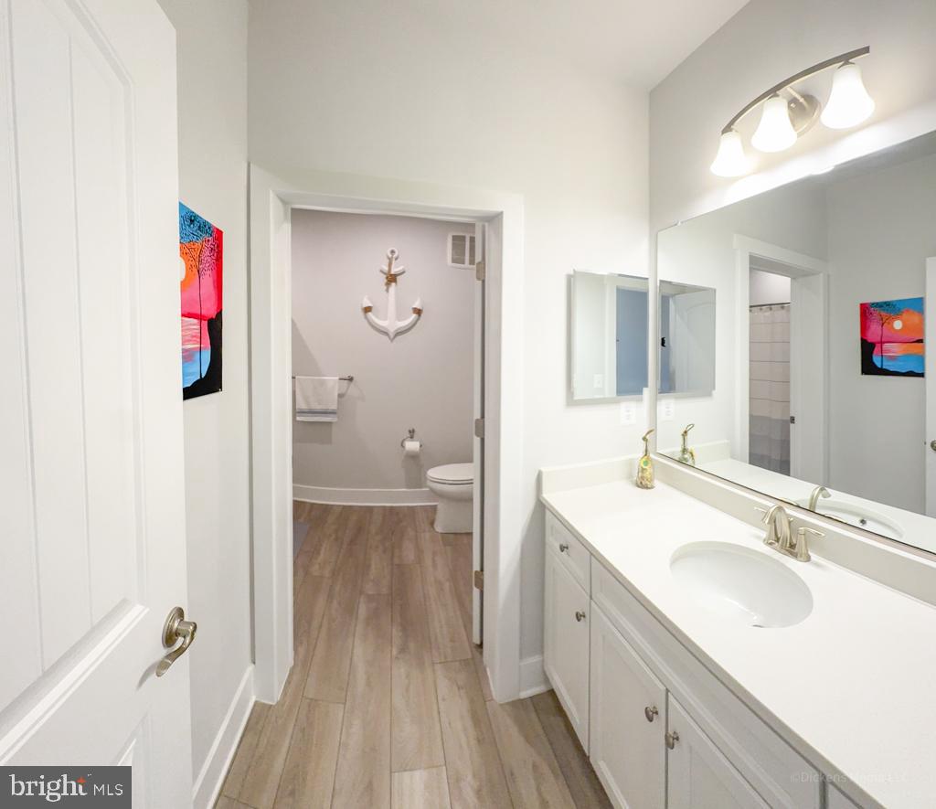 190 Harrier Way, Unit 11 Chester, MD 21619 - Photo 19 of 32 a spacious bathroom with a sink and a mirror