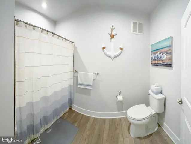 a bedroom with a bed and a wooden floor