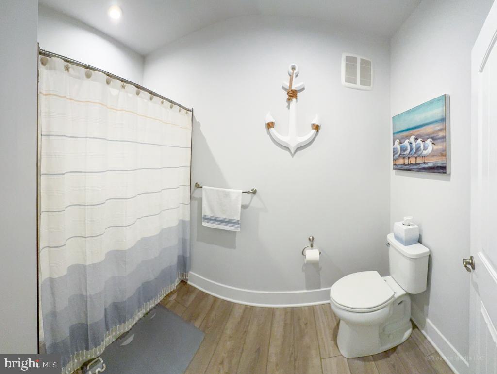 190 Harrier Way, Unit 11 Chester, MD 21619 - Photo 20 of 32 a white toilet sitting next to a bathroom sink