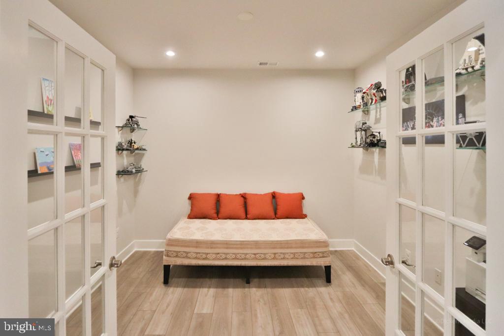 190 Harrier Way, Unit 11 Chester, MD 21619 - Photo 21 of 32 a bedroom with a bed and a wooden floor