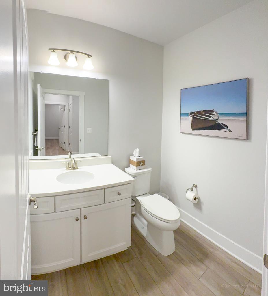 190 Harrier Way, Unit 11 Chester, MD 21619 - Photo 23 of 32 a bathroom with a toilet sink and mirror