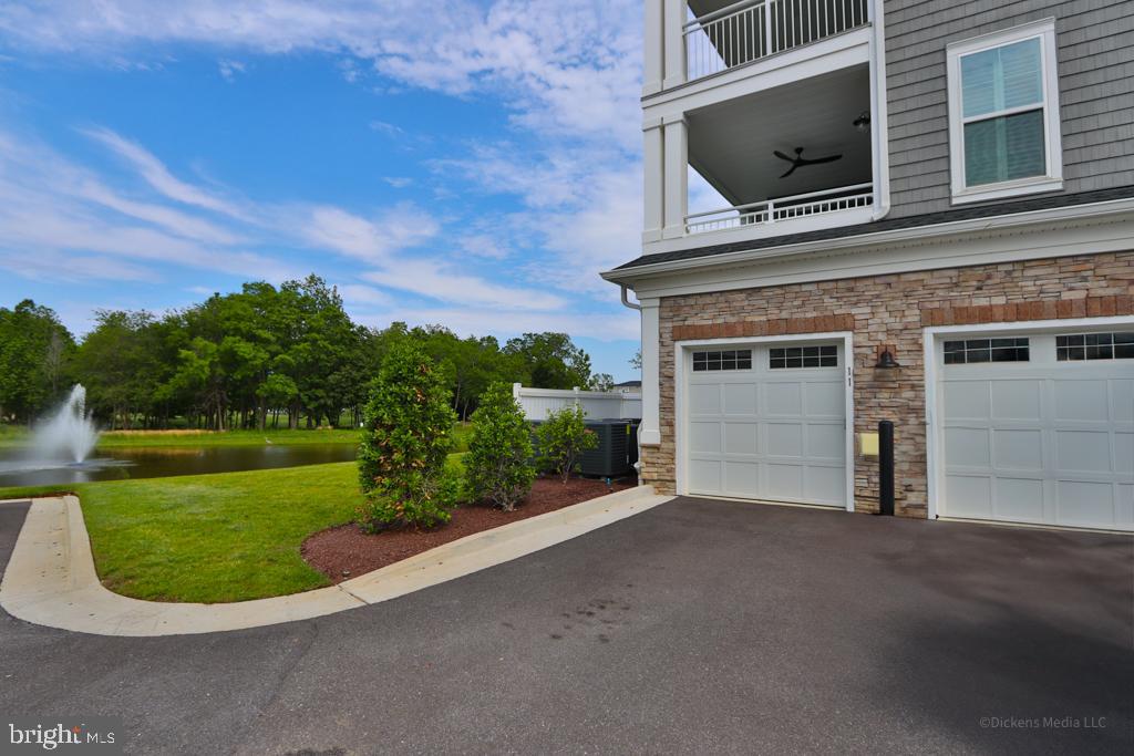 190 Harrier Way, Unit 11 Chester, MD 21619 - Photo 25 of 32 a house view with a garden space