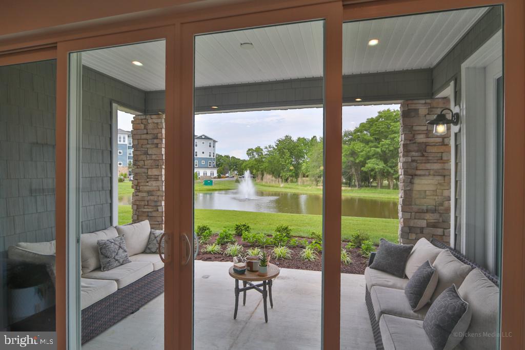 190 Harrier Way, Unit 11 Chester, MD 21619 - Photo 6 of 32 a living room with furniture and a large window