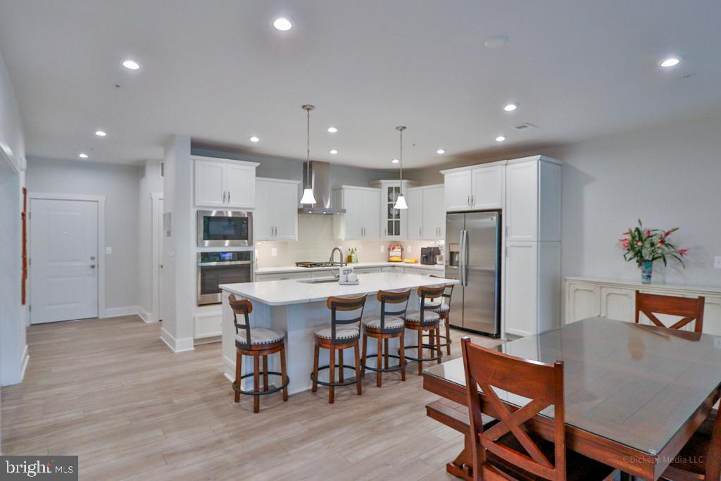190 Harrier Way, Unit 11 Chester, MD 21619 - Photo 7 of 32 a large kitchen with a table and chairs
