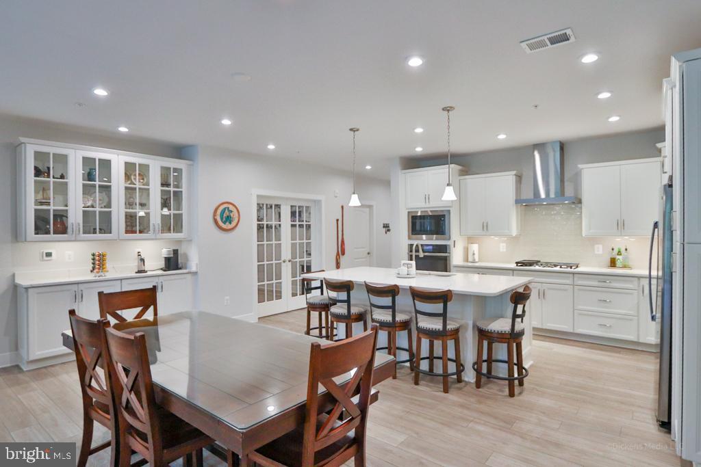 190 Harrier Way, Unit 11 Chester, MD 21619 - Photo 8 of 32 a large kitchen with a table and chairs in it
