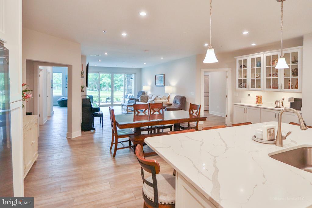 190 Harrier Way, Unit 11 Chester, MD 21619 - Photo 9 of 32 a view of a dining room and livingroom with furniture wooden floor a chandelier