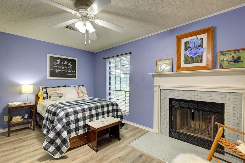 753 County Rd SW 3110 Mount Vernon, TX 75457 - Photo 28 of 40 Bedroom 3 is also upstairs, and has its own tile surround wood-burning fireplace.