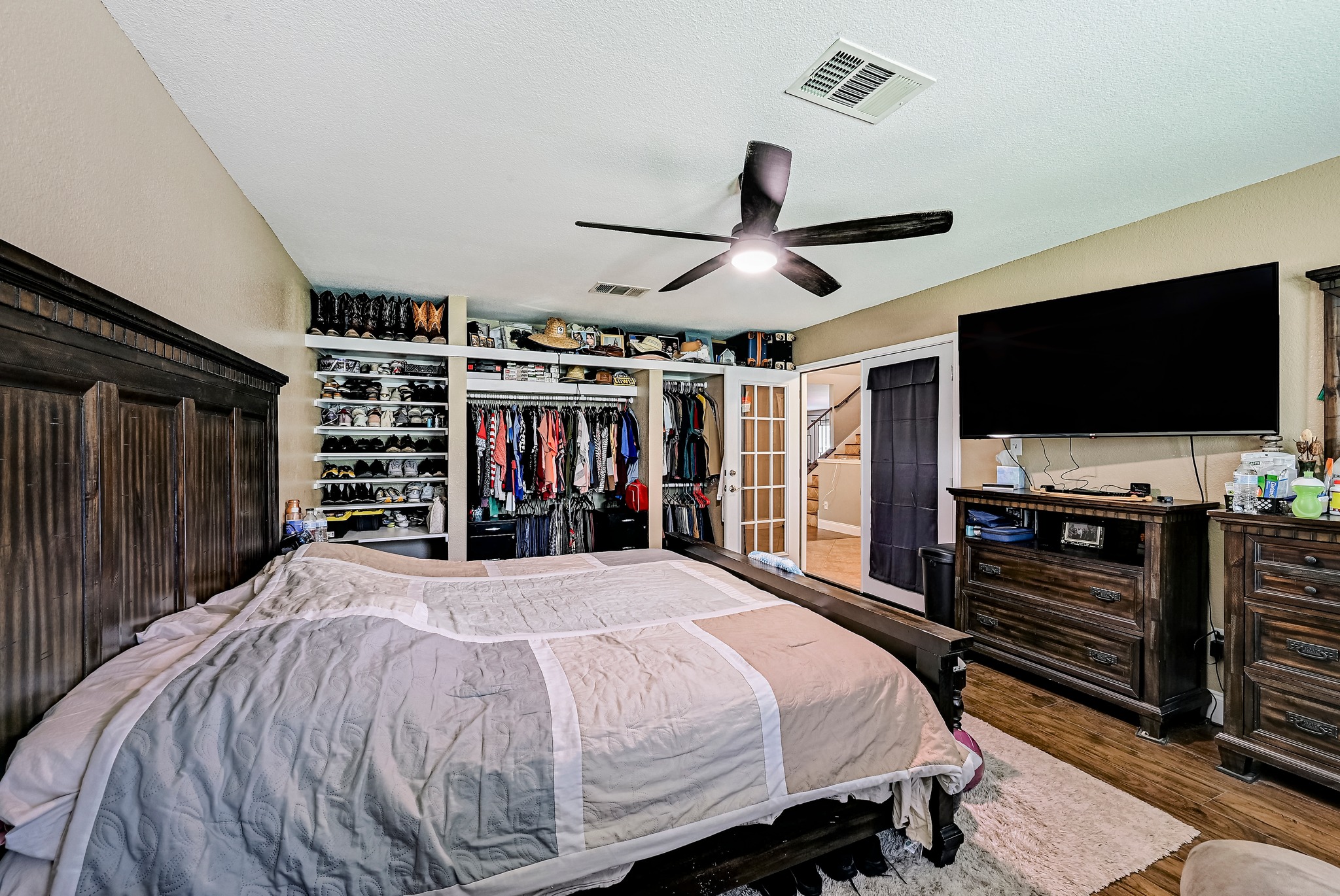 104 North Sumac Lane Georgetown, TX 78633 - Photo 9 of 40 This primary bedroom suite includes built-in closet organization and a ceiling fan for comfort.