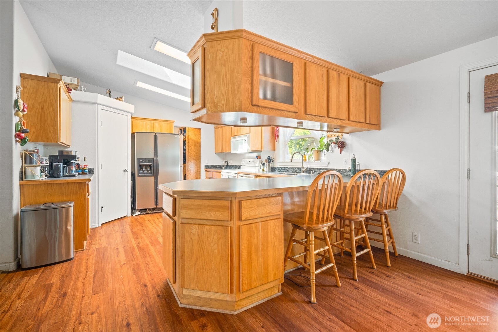 4230 Cody Road Blaine, WA 98230 - Photo 16 of 38 a dining room with furniture a floor to ceiling window and wooden floor