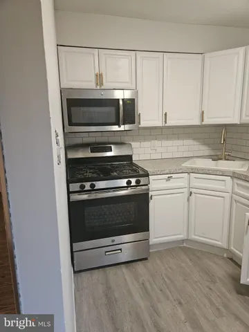 a kitchen with cabinets and appliances