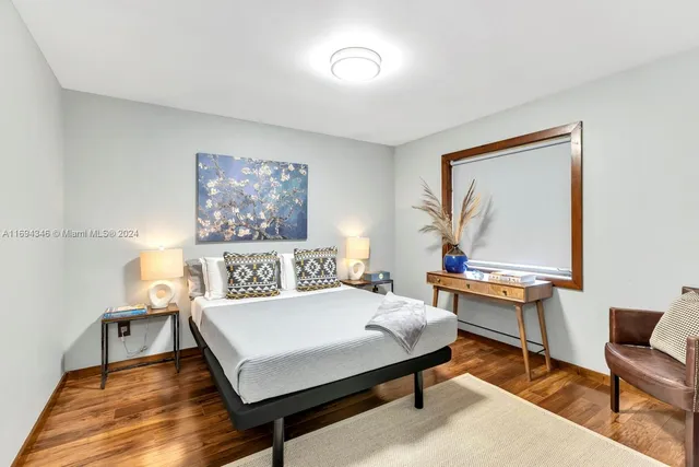 a view of a room with furniture and floor to ceiling window