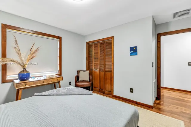 a view of a room with wooden floor and windows