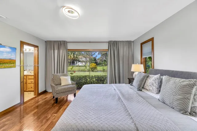 a bathroom with a granite countertop double vanity sink toilet and shower