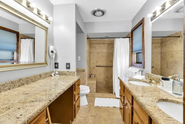 a living room with large windows and a table