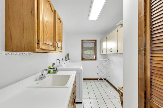 a view of a house with a yard and palm trees