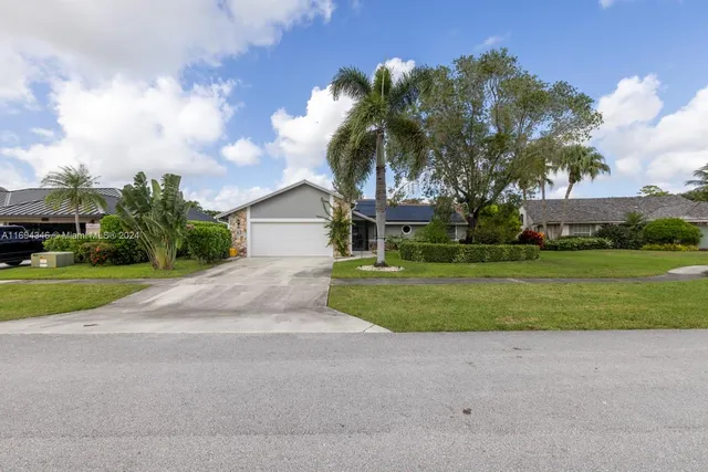 a front view of house with yard and green space