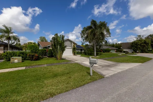 a view of house with garden space and street view
