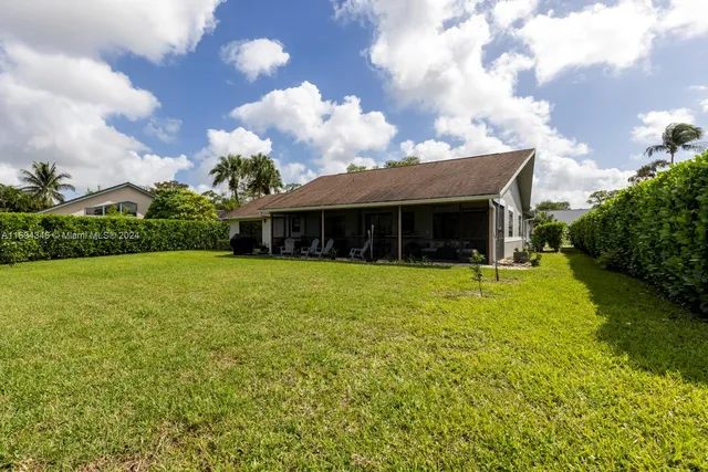 an aerial view of a house with garden space and street view