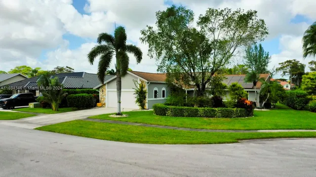 an aerial view of a house with yard and outdoor seating
