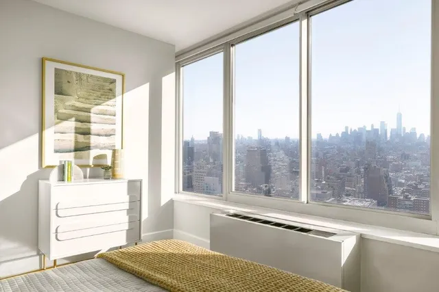 a view of a room that has a bed and a window