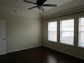 an empty room with wooden floor and a window
