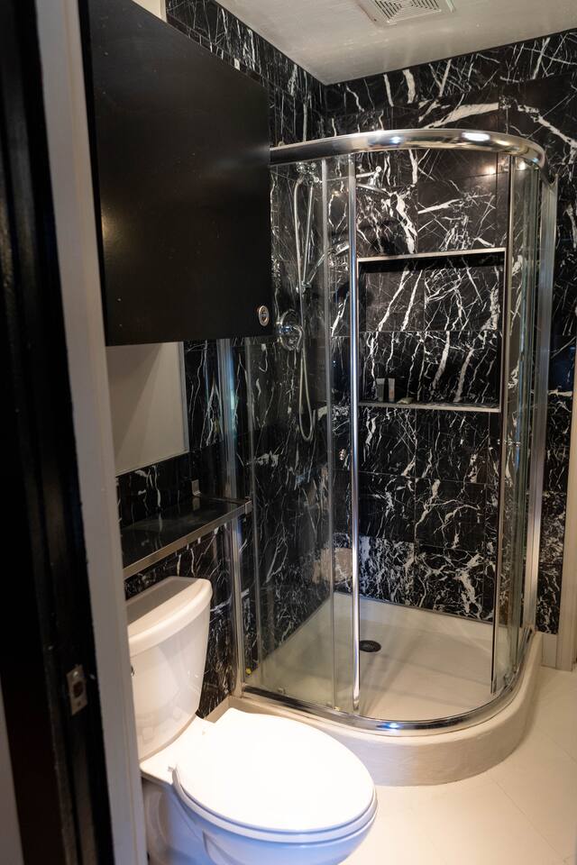 1901 Harmon Hills Road, Unit A Dripping Springs, TX 78620 - Photo 11 of 11 Bathroom with a marble finish shower and tile walls