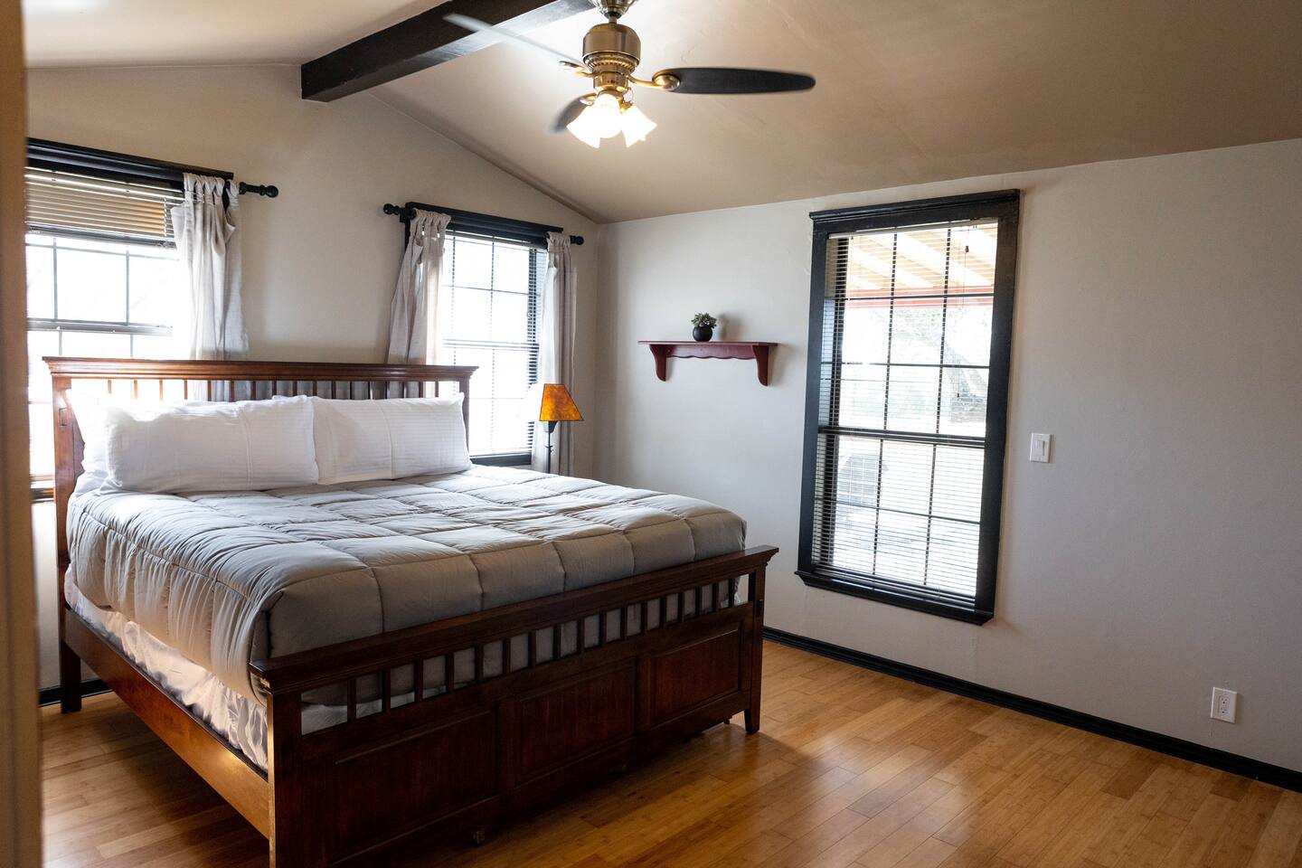 1901 Harmon Hills Road, Unit A Dripping Springs, TX 78620 - Photo 3 of 11 Bedroom with light wood-type flooring, ceiling fan, and beam ceiling