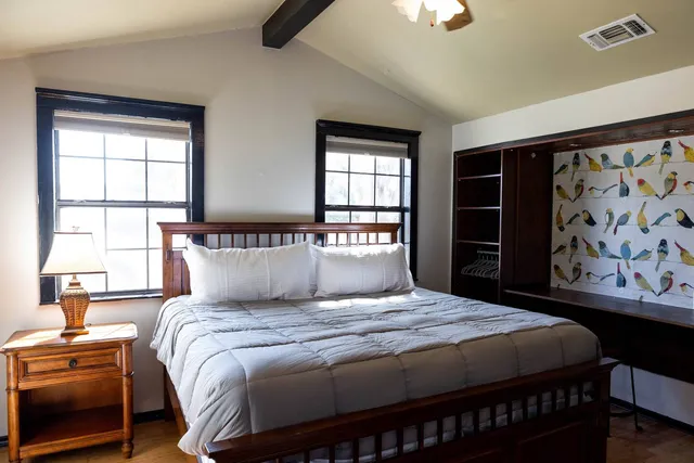 a bedroom with a large bed and a window