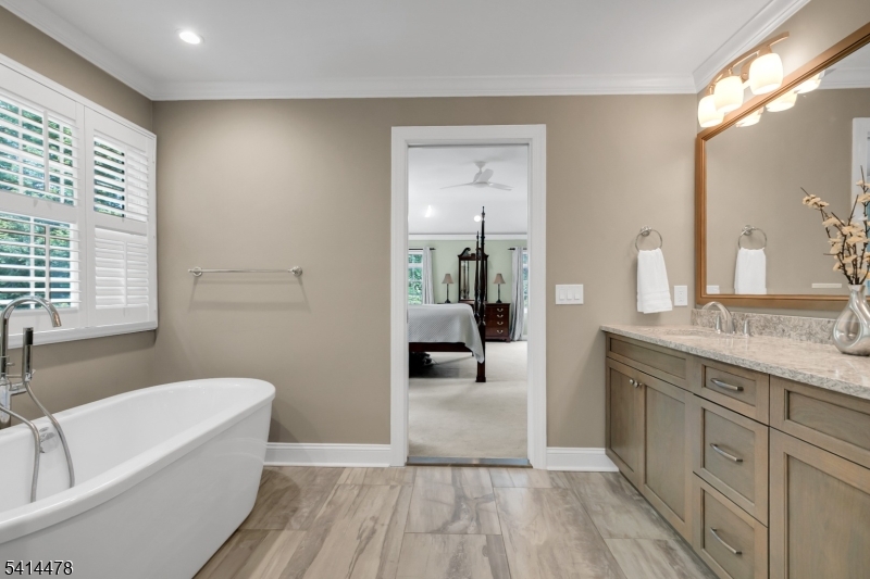 33 St Nickolas Way Bernards, NJ 07920 - Photo 24 of 50 a bathroom with a granite countertop sink a mirror a bathtub and next to a window