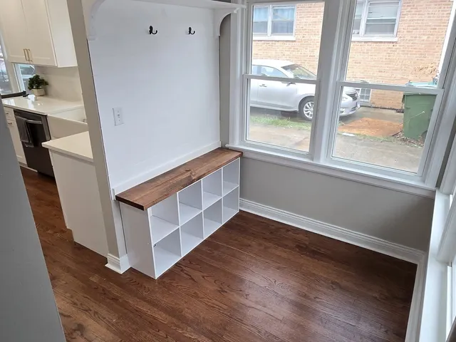 a view of an entryway with wooden floor and windows
