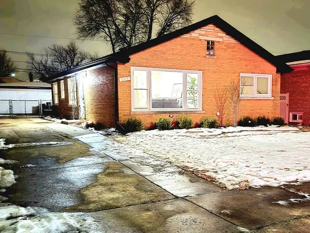 a view of a house with snow on the road