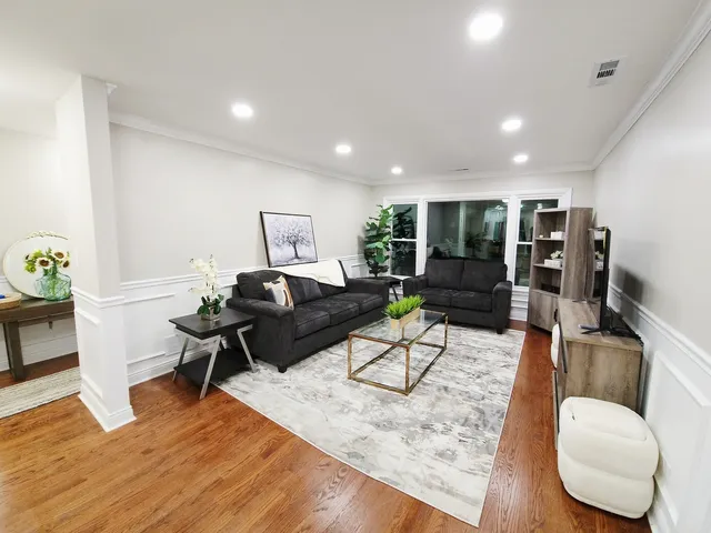 a living room with furniture and wooden floor