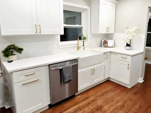 a kitchen with a sink cabinets and wooden floor