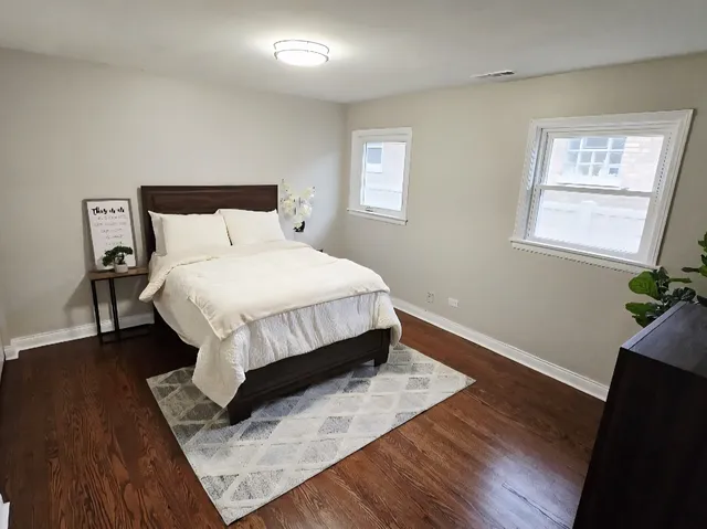 a bed sitting in a bedroom next to a window