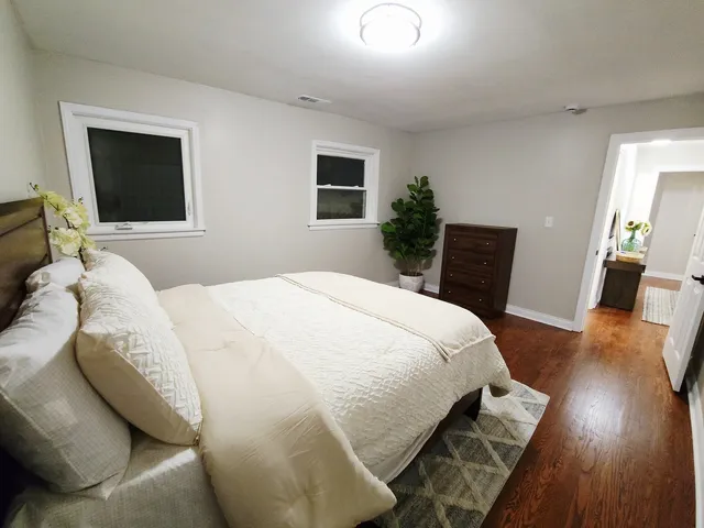 a bedroom with a bed and wooden floor