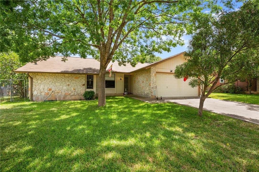 3203 Valley Pike Road Cedar Park, TX 78613 - Photo 1 of 1 a backyard of a house with plants and large tree