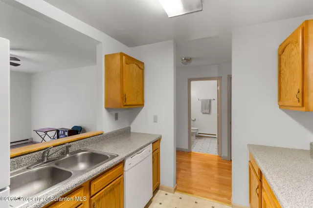 a kitchen with a sink and a refrigerator