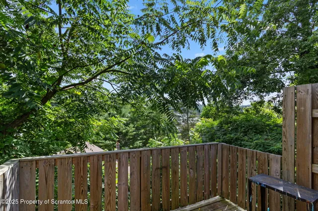 a kitchen with stainless steel appliances kitchen island granite countertop a sink dishwasher and cabinets with wooden floor